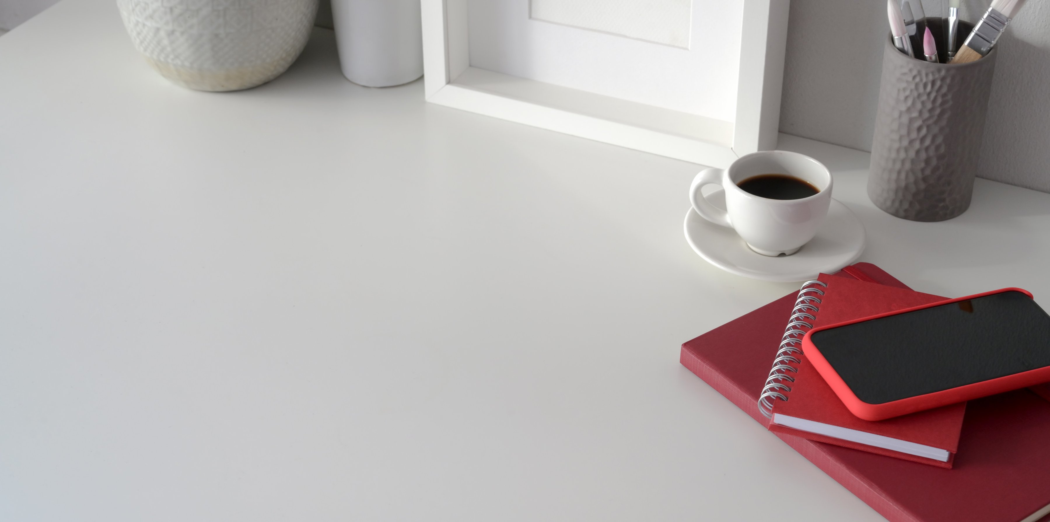 Red Smartphone On Red Notebook